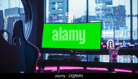 Empty Gaming Station with Green Screen Mock Up Computer Display Standing on a Stylish Table in a Futuristic Cyberpunk Room with Neon Light Stock Photo