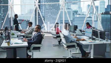 Team of Talented Young Indian Professionals Working in a Corporate Hedge Fund. Financial Analysts and Managers Working on Computers in a South Asian Business Office with Scenic City View Stock Photo