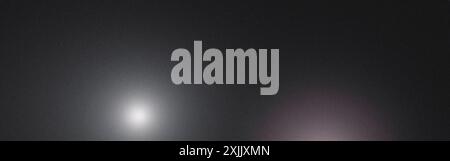 Abstract background featuring a grainy texture with two light spots creating a gradient Stock Photo