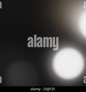Grainy textured backdrop with vibrant white bokeh lights blending into darkness Stock Photo
