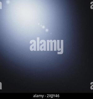 Bright light beam illuminating a blue studio backdrop with space for text Stock Photo