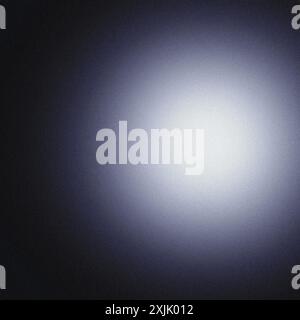 Grainy texture creating a subtle light gradient on a dark background, ideal for adding a touch of elegance to any design project Stock Photo