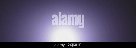 Purple grainy background with a bright centered light Stock Photo