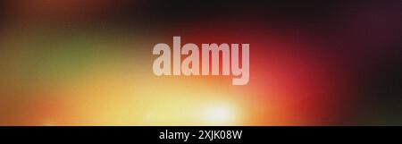 Vibrant abstract background with a blend of yellow, orange, red, and green, featuring a soft light leak and a textured grainy effect Stock Photo