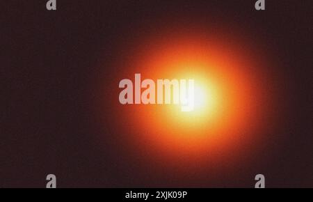 Grainy texture with glowing light effect on a dark background Stock Photo