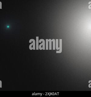 Abstract background with a grainy texture, featuring a small green light and a large white light Stock Photo