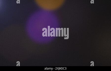 Colorful bokeh with grainy texture forming an abstract background Stock Photo
