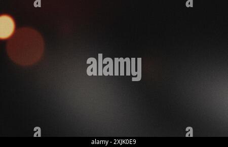 Abstract dark background with blurred lights creating bokeh effect and grainy texture Stock Photo