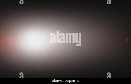 Abstract background featuring a grainy texture with a smooth gradient from white to black Stock Photo