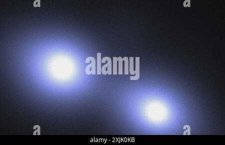 Bright blue lights illuminating a dark blue grunge background with space for text Stock Photo