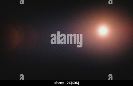 Abstract background with grainy texture, featuring a bright light spot and radial gradient Stock Photo