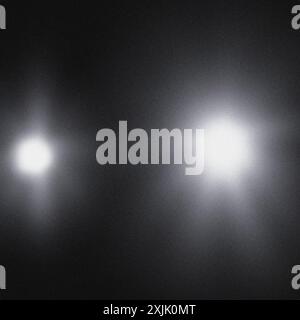 Grainy texture featuring two light sources on dark background, ideal for design projects Stock Photo