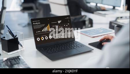 Close-Up On Hands of Caucasian Male Professional Working in a Business Research and Development Company. Manager Analyzing Financial Reports, Looking at a Laptop Computer Screen with Graphs and Charts Stock Photo