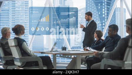 Office Conference Room Meeting Presentation: Caucasian CEO Talks, Uses TV to Show Company Growth with Big Data Analysis, Graphs, Charts, Infographics. Multi-Ethnic e-Commerce Startup Workers. Stock Photo