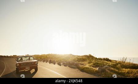 Car, driving and couple on journey at sunset, holiday or vacation together on mockup space on sky. Motor, man and woman travel on road trip in Stock Photo