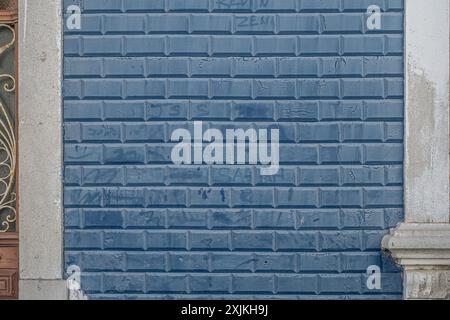 Old blue tiles on the wall Stock Photo