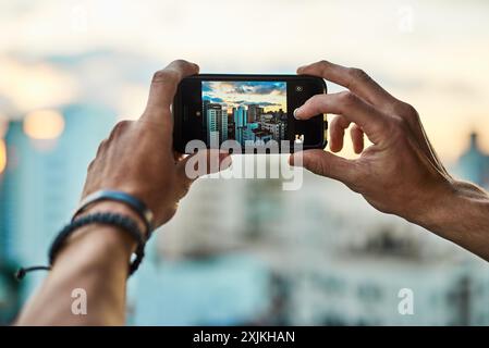 Person, smartphone and screen with city for photography, urban view and mobile phone display for digital image. Hands, closeup and pov of travel photo Stock Photo