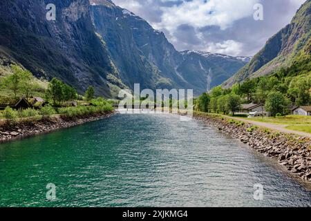 A picturesque landscape of Naeroydalselvi river flowing in Gudvangen village on a sunny day in Aurland Municipality in Vestland county, Norway Stock Photo