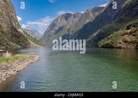 A scenic view of Naeroydalselvi river flowing in Gudvangen village on a sunny day in Aurland Municipality in Vestland county, Norway Stock Photo