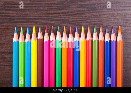 Multicolored pencils on the brown wooden table background Stock Photo
