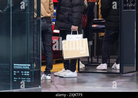 Consumer tourist lugging shopping bags, factory outlet, Outletcity Metzingen with around 80 shops with premium and luxury brands specialising in Stock Photo