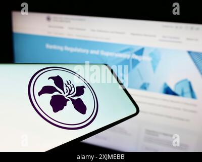 Stuttgart, Germany, 06-18-2022: Smartphone with logo of Hong Kong Monetary Authority (HKMA) on screen in front of business website. Focus on Stock Photo