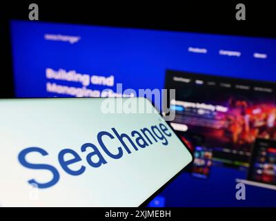 Stuttgart, Germany, 06-18-2022: Cellphone with logo of American company SeaChange International Inc. on screen in front of business website. Focus on Stock Photo