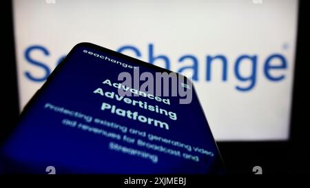 Stuttgart, Germany, 06-18-2022: Mobile phone with webpage of American company SeaChange International Inc. on screen in front of logo. Focus on Stock Photo