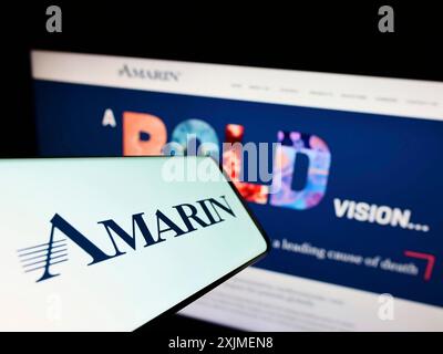 Stuttgart, Germany, 06-11-2022: Smartphone with logo of biopharmaceutical company Amarin Corporation plc on screen in front of website. Focus on Stock Photo