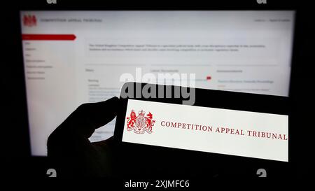 Stuttgart, Germany, 06-18-2022: Person holding cellphone with logo of British body Competition Appeal Tribunal (CAT) on screen in front of webpage. Stock Photo