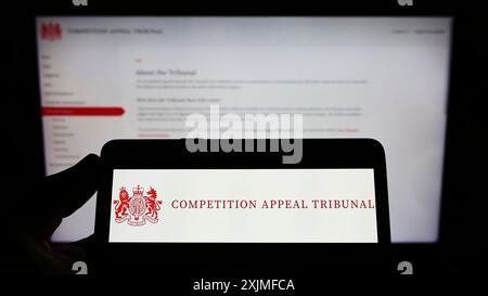 Stuttgart, Germany, 06-18-2022: Person holding smartphone with logo of British body Competition Appeal Tribunal (CAT) on screen in front of website. Stock Photo