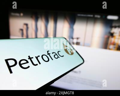 Stuttgart, Germany, 07-16-2022: Cellphone with logo of British energy services company Petrofac Limited on screen in front of website. Focus on Stock Photo
