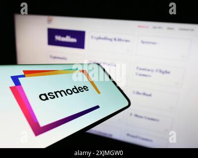 Stuttgart, Germany, 07-16-2022: Smartphone with logo of French games company Asmodee Editions on screen in front of business website. Focus on Stock Photo