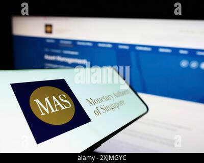 Stuttgart, Germany, 07-16-2022: Cellphone with logo of Monetary Authority of Singapore (MAS) on screen in front of website. Focus on center-left of Stock Photo