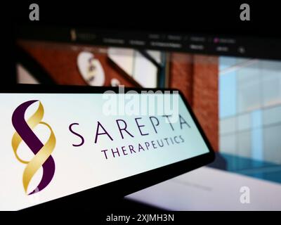 Stuttgart, Germany, 07-16-2022: Smartphone with logo of American company Sarepta Therapeutics Inc. on screen in front of business website. Focus on Stock Photo