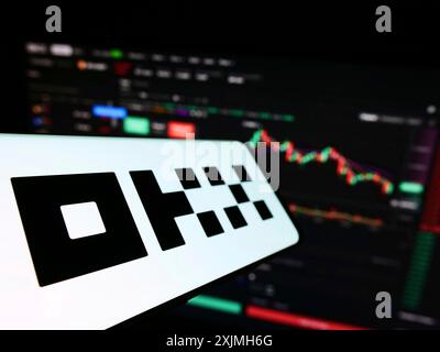 Stuttgart, Germany, 07-17-2022: Smartphone with logo of crypto company Aux Cayes FinTech Co. Ltd. (OKX) on screen in front of website. Focus on Stock Photo