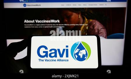 Stuttgart, Germany, 07-31-2022: Person holding smartphone with logo of health partnership Gavi, the Vaccine Alliance on screen in front of website. Stock Photo