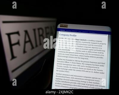 Stuttgart, Germany, 08-27-2022: Person holding cellphone with webpage of Canadian company Fairfax Financial Holdings Limited on screen with logo. Stock Photo