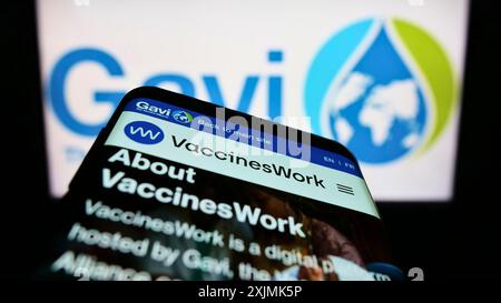 Stuttgart, Germany, 07-31-2022: Smartphone with webpage of health partnership Gavi, the Vaccine Alliance on screen in front of business logo. Focus Stock Photo