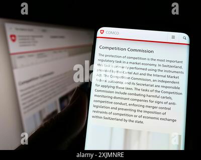 Stuttgart, Germany, 09-19-2022: Person holding cellphone with web page of competition commission Wettbewerbskommission (Weko) on screen. Focus on Stock Photo