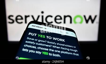 Stuttgart, Germany, 12-31-2022: Mobile phone with website of US software company ServiceNow Inc. on screen in front of business logo. Focus on Stock Photo