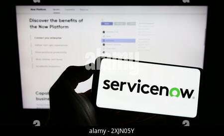 Stuttgart, Germany, 12-31-2022: Person holding cellphone with logo of US software company ServiceNow Inc. on screen in front of business webpage. Stock Photo