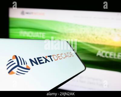 Stuttgart, Germany, 03-07-2023: Cellphone with logo of American energy company NextDecade Corporation on screen in front of website. Focus on Stock Photo