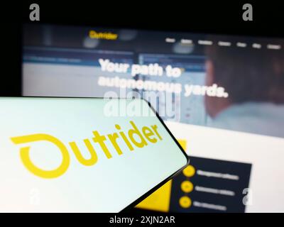 Stuttgart, Germany, 03-07-2023: Smartphone with logo of American company Outrider Technologies Inc. on screen in front of website. Focus on Stock Photo