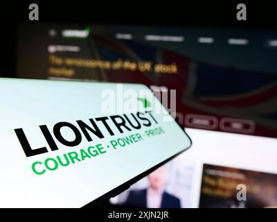 Stuttgart, Germany, 03-08-2023: Cellphone with logo of British company Liontrust Asset Management plc on screen in front of business website. Focus Stock Photo