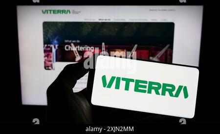 Stuttgart, Germany, 03-08-2023: Person holding cellphone with logo of commodity trading company Viterra Limited on screen in front of business Stock Photo