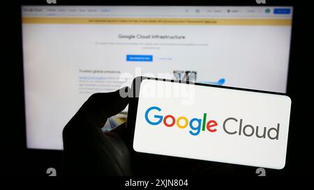 Stuttgart, Germany, 06-18-2023: Person holding cellphone with logo of computing services Google Cloud Platform (GCP) on screen in front of webpage. Stock Photo