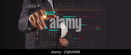 A professional in a suit interacts with a digital construction management interface, adjusting a project timeline displayed on a transparent virtual s Stock Photo
