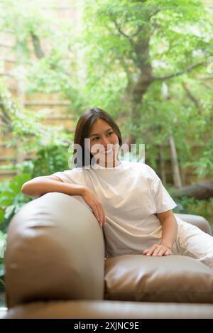 Young Thai Woman Smiling Indoors at Coffee Shop Concept Stock Photo