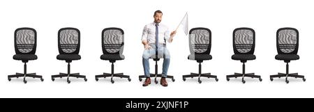 Sad businessman sitting between empty office chairs and holding a white flag isolated on white background Stock Photo